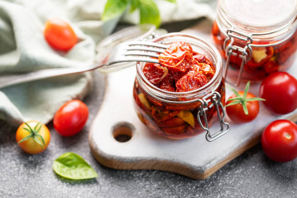 istock Jars with sun dried tomatoes with fresh herbs and spices. 1714359987