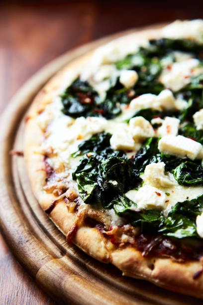 istock Pizza with mozzarella cheese and spinach. Dark wooden background. Close up. 1714361015