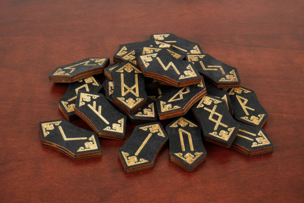 istock Heap of black wooden runes on table 1714361299