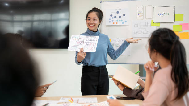 istock Young smart UX UI designer presenting her idea to the team, presentation during the team meeting. 1714369919