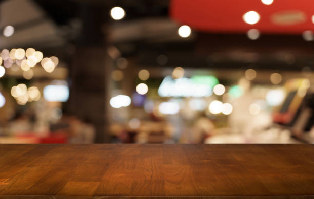 istock Mock up for space. Empty dark wooden table in front of abstract blurred bokeh background of restaurant . can be used for display or montage your product 1714396647