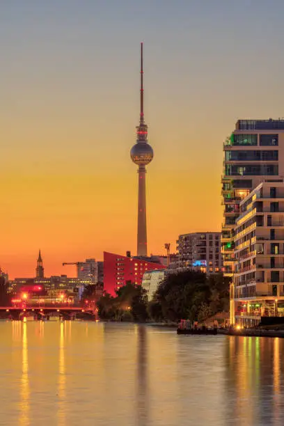 The famous TV Tower in Berlin with the Spree river after sunset