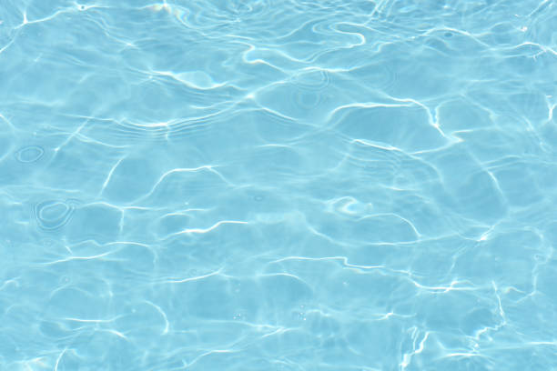istock Defocus blurred transparent blue colored clear calm water surface texture with splashes reflection. Trendy abstract nature background. Water waves in sunlight with copy space. Blue watercolor shine. 1714404711