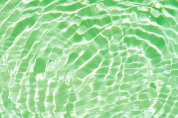 istock Defocus blurred transparent blue colored clear calm water surface texture with splashes reflection. Trendy abstract nature background. Water waves in sunlight with copy space. Blue watercolor shine. 1714407684