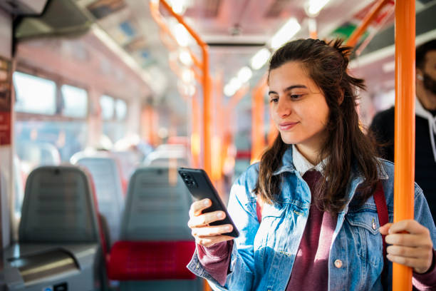 istock Young woman using the mobile phone in the subway train. 1714438033