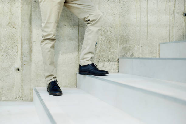 istock Unrecognizable man standing on stairs. 1714479278