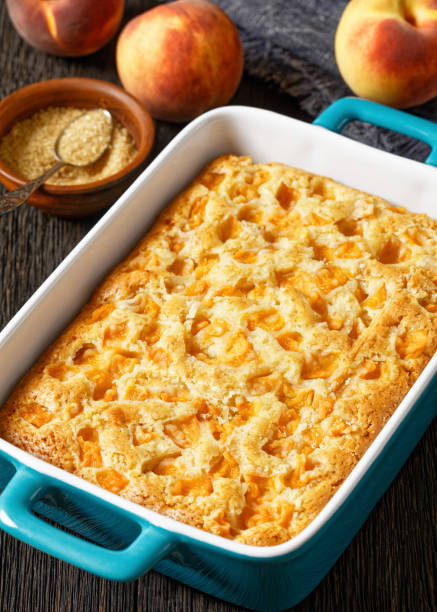 istock peach cake in baking dish on dark wooden table 1714485407