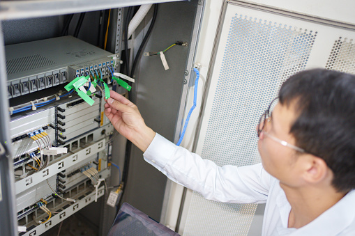 Man inspecting communication base station server