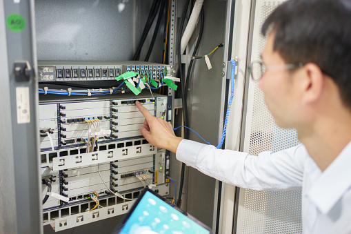 Man inspecting communication base station server