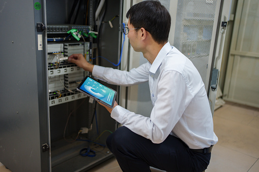 Man inspecting communication base station server