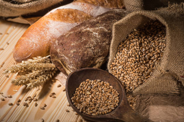 istock Assortment of baked bread on wooden table background 1714493618