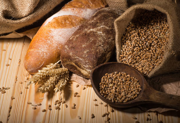 istock Assortment of baked bread on wooden table background 1714493625