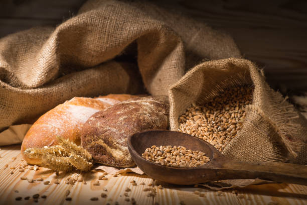 istock Assortment of baked bread on wooden table background 1714493626