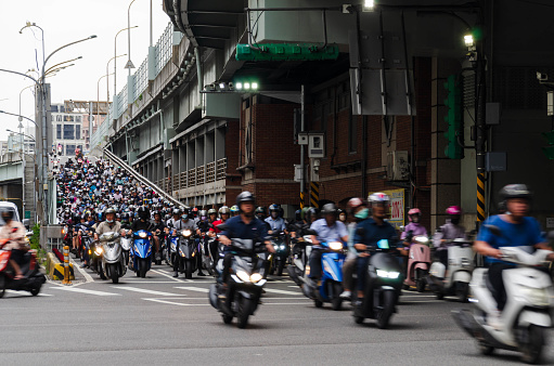 traffic street view to the road bridge from highway full with many motorcycle vehicle heavy traffic inbound to the city of Taipei in Taiwan in morning rush hour