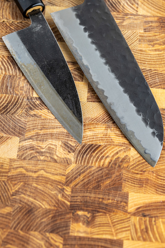 Closeup of a generic knife and slate sharpening stone on a white background.