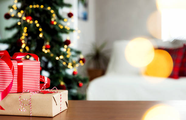 istock Christmas, New Year background. Empty wooden tabletop with bokeh fir tree, gift 1714501211
