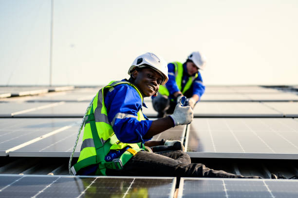 istock Maintenance technicians installing solar panels at solar cell farm 1714504446