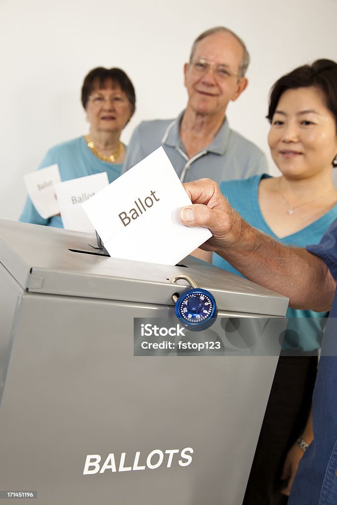 People in line casting votes. Voting political election. Ballot box. Voters casing their ballots. Mixed ages voters.  MORE LIKE THIS... in lightboxes below! Voting Stock Photo