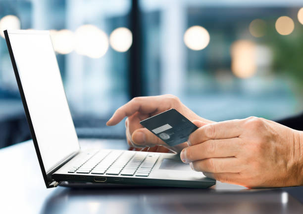 istock Hands holding credit card and using laptop. Online shopping 1714531137