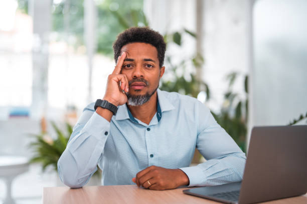 istock Confident Black Businessman at Office Desk with Laptop 1714543195