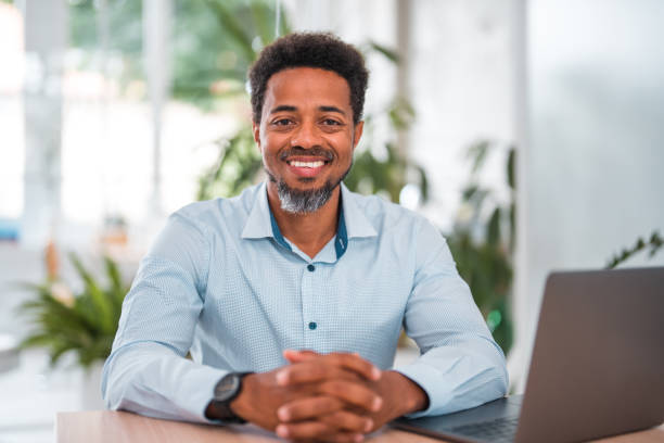 istock Aspired Black Male Executive at Office Table with Laptop 1714543196
