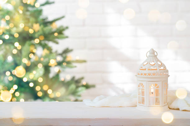 Christmas background with candle light lantern on table with space