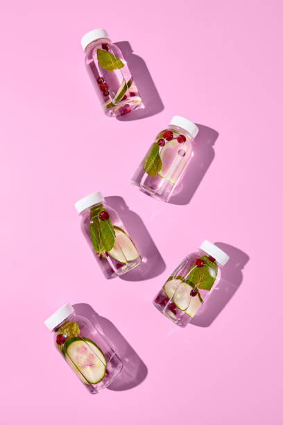 istock Plastic bottle mockup on empty pink background. Set from detox water with cucumber, mint and berries. Design bottle mockup. Beverage for healthy, sport or diet. Detox drink in transparent bottle. 1714576924