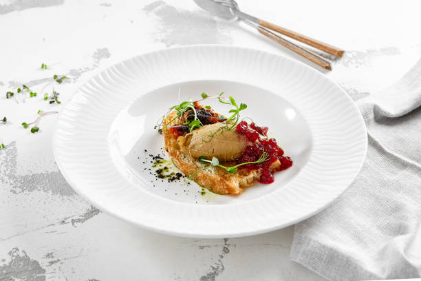 istock Chicken liver pate on crispy bread with red currant jam and micro green. Bruschetta with chicken pate in white plate. Delicious appetizer - foie gras on toast. Liver pate with jam in rustic style. 1714576933