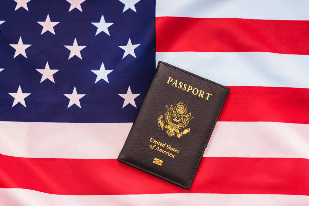 istock American passport next to a patriotic flag. 1714583567