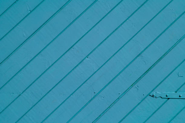 Fragment of a wooden gate painted blue.