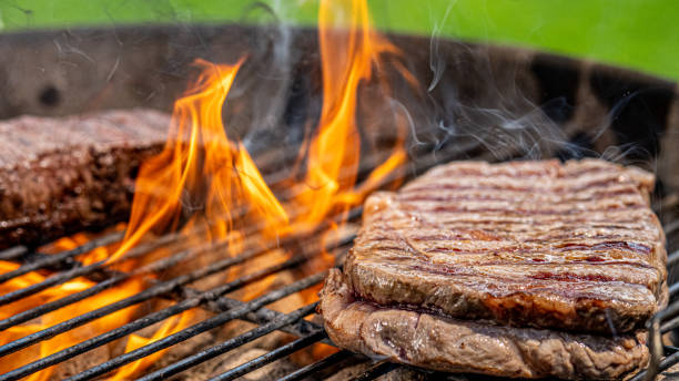istock Beef steak roasting on a wired charcoal barbecue grill 1714600187