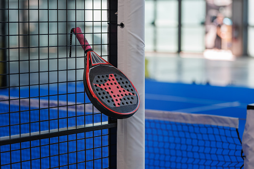 Padel Racket Strung in the Outdoor Structure Surrounding the Playing Field