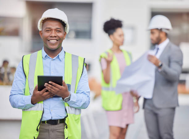 istock Happy black man, architect and tablet in city, team planning or construction on rooftop at site. African male person, engineer or contractor on technology in leadership, project or architecture plan 1714606637