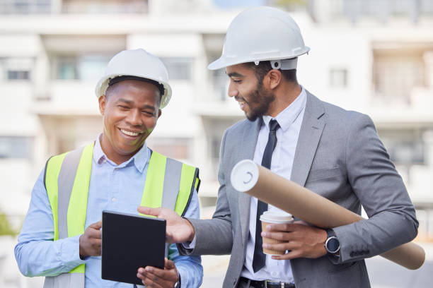 istock Happy people, architect and tablet in city for team planning, construction or strategy on rooftop at site. Men, engineer or contractor on technology in teamwork, project or architecture plan in town 1714606787