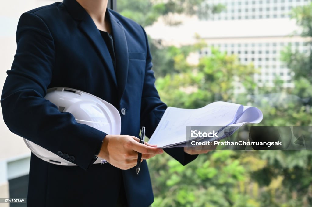 Construction Engineering Manager Engineer Manager Holding Helmet And Blueprints While Planning New ...