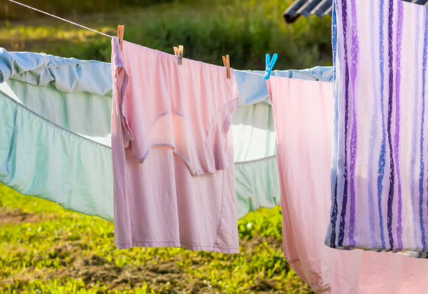 istock Clean washed laundry hanging on the rope outdoors. 1714608946
