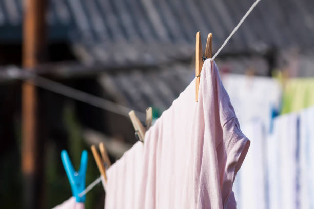 istock Clean washed laundry hanging on the rope outdoors. 1714615139