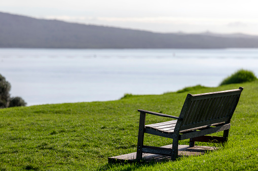 rest place with wooden bench at calm sunrise