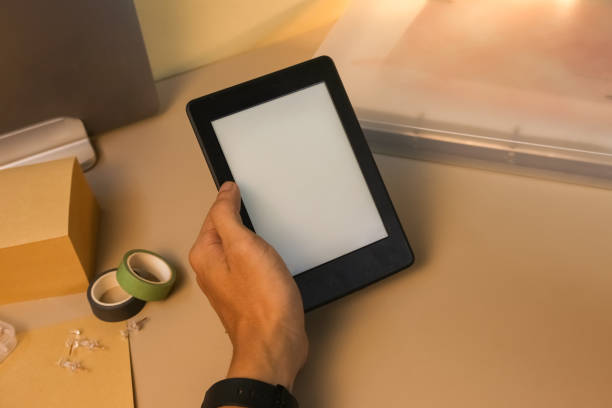 istock Reading E-book with Amazon paperwhite 3 Kindle stock photo 1714633967