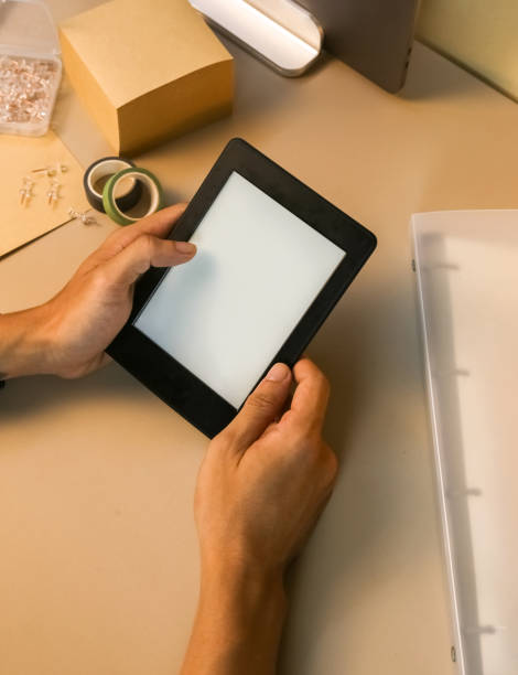 istock Reading E-book with Amazon paperwhite 3 Kindle stock photo 1714633969