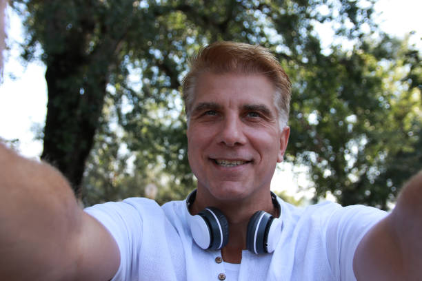 istock Mid aged blonde man take a selfie 1714646958
