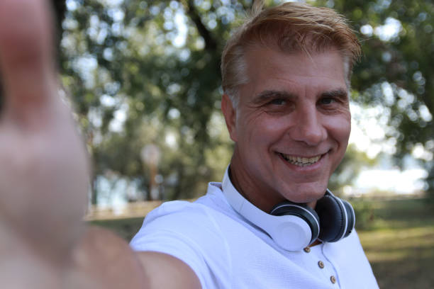 istock Mid aged blonde man take a selfie 1714646963