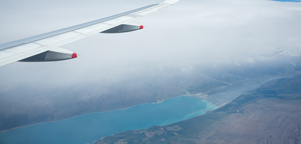 Aerial view of Lake Pukaki in heavy fog, from an airplane flying from Auckland to Queenstown. South Island. New Zealand.