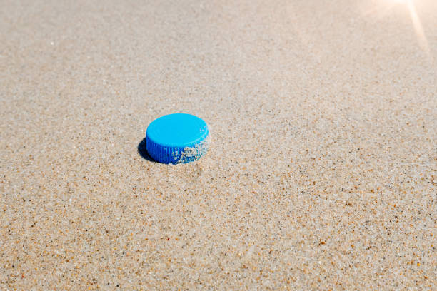 istock Plastic plug on the clean sand of a beach. 1714683424