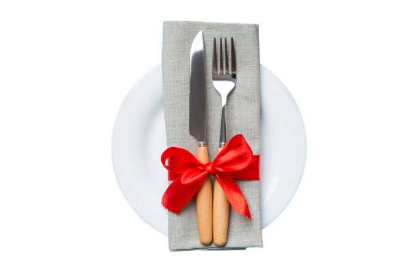 istock isolated christmas Plate with decor and fork and spoon. New year holiday background. Top view 1714684479