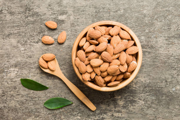 istock Fresh healthy Almond in bowl on colored table background. Top view 1714684550