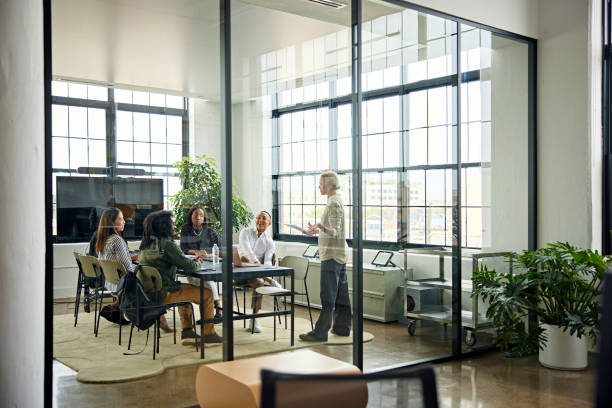 istock Smiling colleagues meeting in modern conference room 1714739021