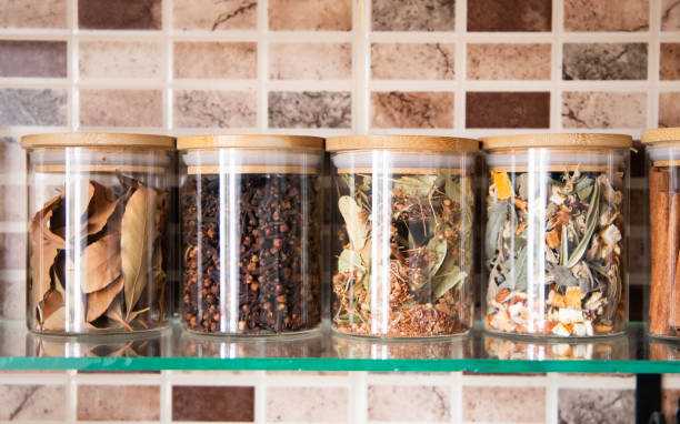 istock Hand holding spice jar on kitchen counter. 1714739577