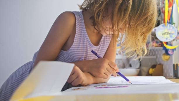 istock Young Caucasian Girl Doing Homework for Elementary School 1714747581