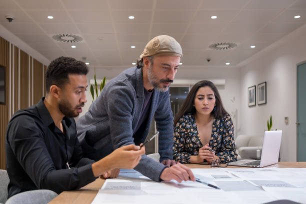 istock Project manager working with employees in a coworking 1714771648